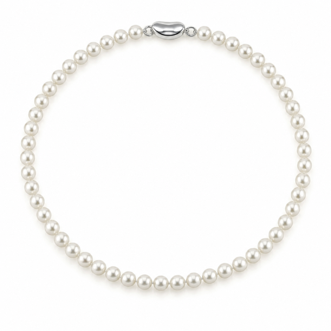White pearl necklace with evenly spaced round pearls and oval metal clasp