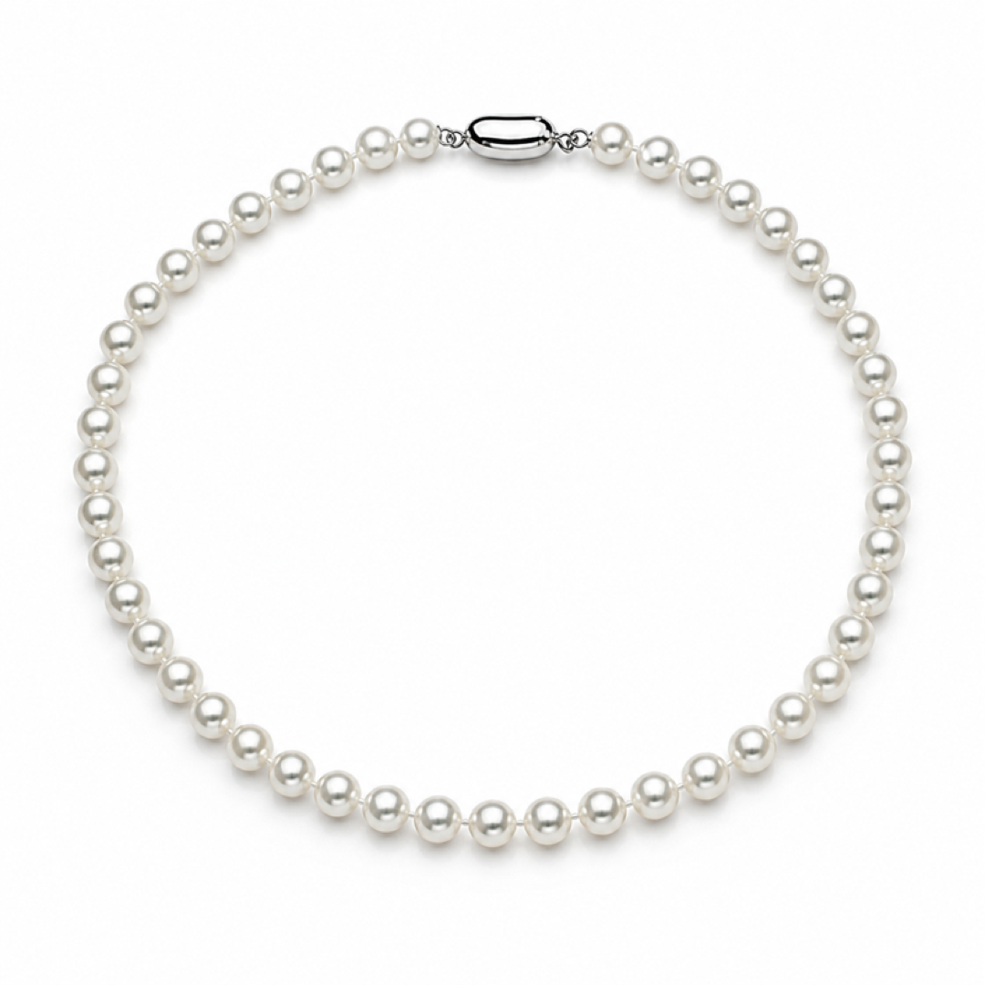 White pearl necklace with evenly spaced round pearls and oval silver clasp